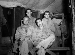 Engineers of the 797th Engineer Forestry Company pose in their barracks in Burma.  During WWII.