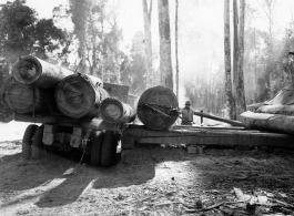 Site at the mill yard, a large truck unloading logs at a lumber mill of the 797th Engineer Forestry Company in Burma.  During WWII.