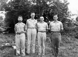 Engineers of the 797th Engineer Forestry Company pose before trees in Burma.  During WWII.