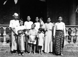 Local people in Burma near the 797th Engineer Forestry Company--Man, women, and children, and a happy puppy.  During WWII.