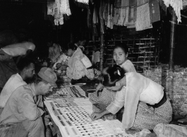 Local people in Burma near the 797th Engineer Forestry Company--A GI visits a jewel shop in Burma.  During WWII.