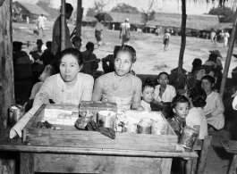 Ladies vending cigars, cigarettes, white face powder, etc., at an activity in Burma.  In Burma near the 797th Engineer Forestry Company.  During WWII.