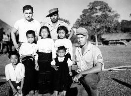 Local people in Burma near the 797th Engineer Forestry Company--GIs pose with man and children in Burma.  During WWII.