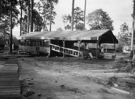 Jungle theater with raised wooden bleachers, covered, with open sides.  797th Engineer Forestry Company in Burma,  During WWII.