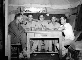 Engineers of the 797th Engineer Forestry Company pose in their barracks/tent in Burma.  During WWII.