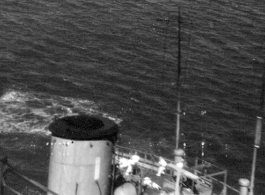 Near miss on a Japanese freighter, with white-suited Japanese sailors scrambling about the deck. From an October 16, 1944, mission on Hong Kong, 491st Bomb Squadron.