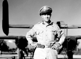 An American flyer in the CBI standing by the tail of a B-25 in the CBI.