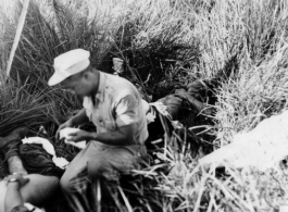 A medic attending to a victim of a bomb accidently exploding during a demonstration.