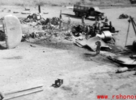 "What One Small Fragmentation Bomb Could Do--This B-24 was hit with one small fragmentation bomb during one of the nightly air raids at Luichow [Liuzhou], China.This particular plane just happened to be a new B-24 that had never flown a mission. As bad as it looks it was not a total loss since the engines were removed, inspected and run-outs done on the crankshafts to be sure they were not damaged. All the engines were used to replace blown engines on the B-24's that were flying gas into China from India. T