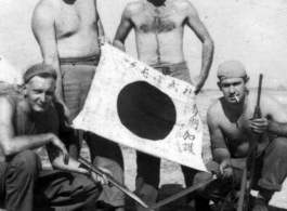 GIs show off trophy captured Japanese Good-Luck Flag  (寄せ書き日の丸) collected on the battleground in the CBI during WWII.