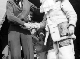 Santa Claus, in full costume, makes an air transport arrival in the CBI during WWII.