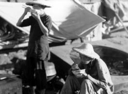 Chinese refugees take a meal at the train station in Liuzhou during WWII, in the fall of 1944.