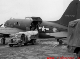 A C-46, #296779, loading or unloading cargo in the CBI during WWII.