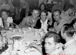 16th Combat Camera Unit members and others--including a few obvious civilians--enjoy a banquet in China during WWII. 