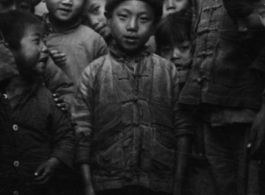 Local people in southern China during WWII: A cool kid in front of the photographer. During WWII.