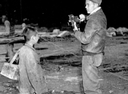 16th Combat Camera Unit photographer Hal Geer takes pictures in China during WWII. The person with him might be an assistant.