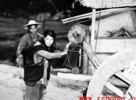 Chinese refugees push a cart of possession in Guangxi province, China, during WWII, in the fall of 1944, as the Japanese advanced during the Ichigo campaign.