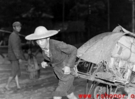 A fleeing Chinese refugee pulls possession on a cart in Guangxi province, China, during the fall of 1944, in the face of the Japanese Ichigo campaign.