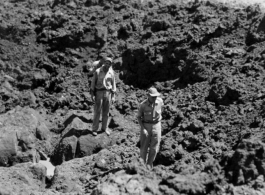 American GIs crossing bomb crater on their way to a burning P-40, October 9, 1944.  This is in Guangxi province, either Guilin or Liuzhou.