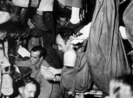 GIs crowded very tightly on bunks on ship on the way back to the US after the war. The ship is probably the SS Marine Raven.