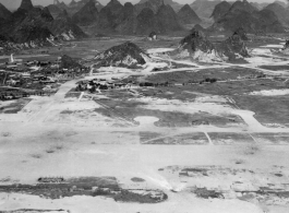 Aerial view of one of the runways at Guilin, Guangxi, China, during WWII.  Notice bomb or demolition holes in runway.  Image from U. S. Government official sources.