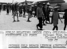 When the Japanese left the former Fourteenth Air Force Base at Liuchow, they left it heavily mined and pockmarked with bomb craters. Workers set out to repair the damage, while engineers of the Fourteenth Air Force, flown in by L-5s (in the background) survey the possibilities for quick repair.