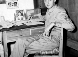 An American serviceman in the CBI writing at his desk in the barracks.  From the collection of Wozniak, combat photographer for the 491st Bomb Squadron, in the CBI.