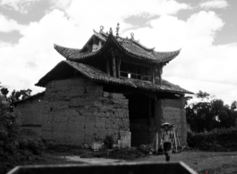 An adobe brick building in countryside in China during WWII, probably in Yunnan province.