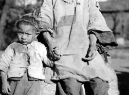 Local people in China, probably in Yunnan province during WWII: An elderly woman and child.