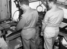 Photographic technicians at work in a photo lab somewhere in the CBI.