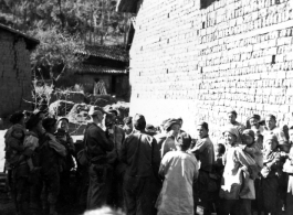 An American photographer interacts with local people in a village in Yunnan during WWII.