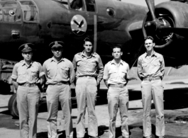 Officers of the 22nd Bombardment Squadron stand before one of the squadron's B-25's (C or D model) at Chakulia Air Base, India.