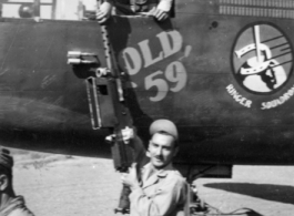 Eugene Montgomery passes a .50 cal machine gun up to Lloyd Kershaw, leaning out of the "green house" at Yangkai Airbase, China, in March 1944. They were preparing "Old '59'" for the beginning of its trip back to the USA where the the war weary B-25 and its original crew, from the 491st "Ringer Squadron" would tour on a War Bond drive.