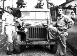 American GIs in China during WWII, with a carbine and the small animal they have hunted on their jeep.