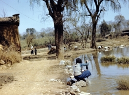 Women wash clothing in a rural village near the American base at Yangkai, Yunnan province, in the CBI.