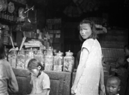 Kids in a small retail shop in China during WWII.    From the collection of David Firman, 61st Air Service Group.