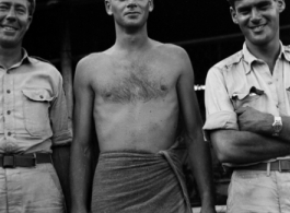 Three GIs pose for the camera--including one in a bath towel--in the CBI during WWII.    From the collection of David Firman, 61st Air Service Group.