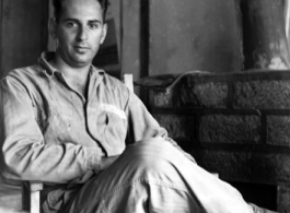 A GI sits and poses in a club in the CBI during WWII.    From the collection of David Firman, 61st Air Service Group.