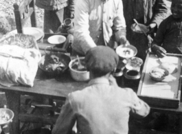 Chinese civilians eat a nice meal in the CBI during WWII.