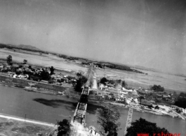 An aerial photograph of a railway bridge being bombed by the 491st Bomb Squadron in Yunnan or Indochina, during WWII.