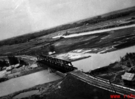 An aerial photograph of a railway bridge being bombed by the 491st Bomb Squadron in Yunnan or Indochina, during WWII.