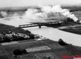 An aerial photograph during battle in the CBI--The approach to a railway bridge in SW China or Indo-China has been bombed by a plane of 491st Bomb Squadron, 341st Bombardment Group.