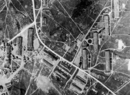 An aerial reconnaissance photograph shAn aerial reconnaissance photograph showing an enemy base in the midst of bombing, and zig-zag trenches on the ground, in the CBI during WWII. an enemy base in the midst of bombing.