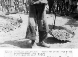 Young girl shoulders carrying-pole to repair runway at Liuzhou, Guangxi province, in the CBI, after Japanese retreat after Ichigo.