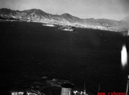 An American bombing raid on Japanese shipping, running just feet above a Japanese ship. Notice the white-suited sailors, probably Japanese or Korean, in action on the ship.