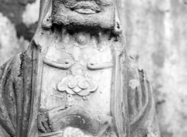 A weathered Buddhist figurine in China during WWII.