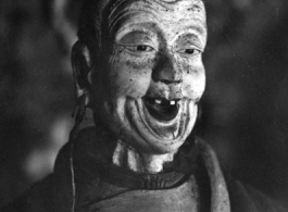 A figure inside a Buddhist temple in China during WWII.