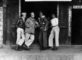 American GIs and Chinese man stand in front of a photo shop, the Wen Hwa Studio (文化摄影社), in China during WWII.