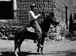 Local people in China: A man in rural China rides a donkey during WWII.  From the collection of Eugene T. Wozniak.