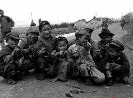 Local kids roadside in China give a 'ding hao' thumbs up during WWII.  From the collection of Eugene T. Wozniak.